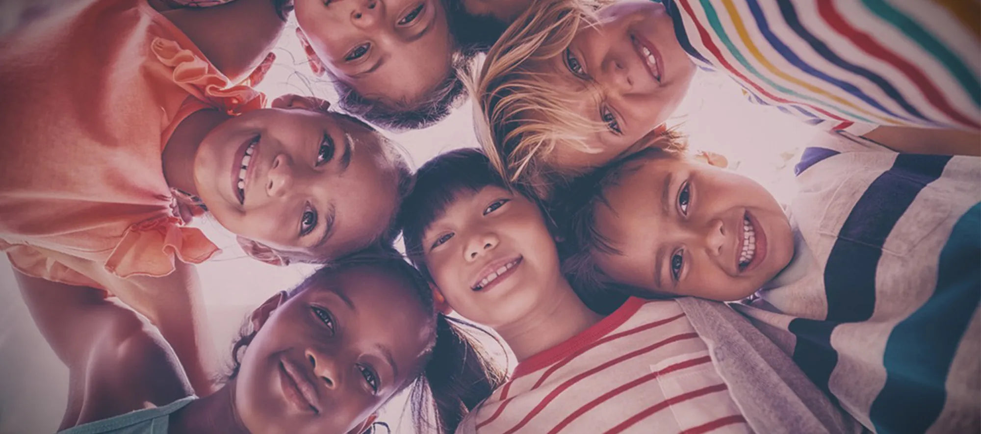 Children of different skin colors gathered together and looked down