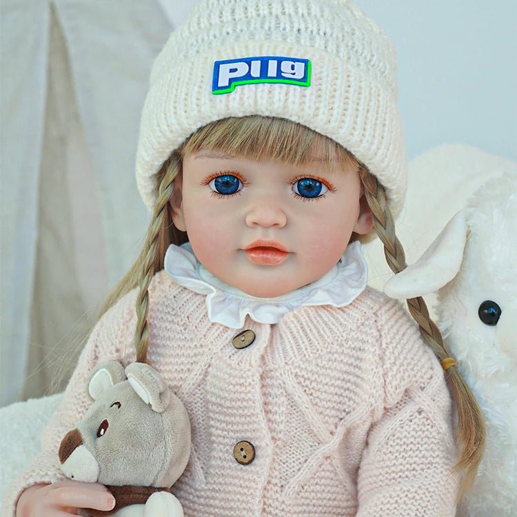 cute toddler doll with long yellow hair, blue eyes, and a beige outfitchimidoll