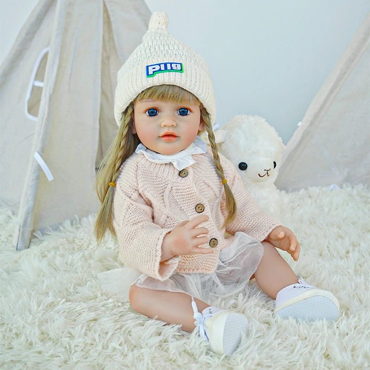 cute toddler doll with long yellow hair, blue eyes, and a beige outfitchimidoll