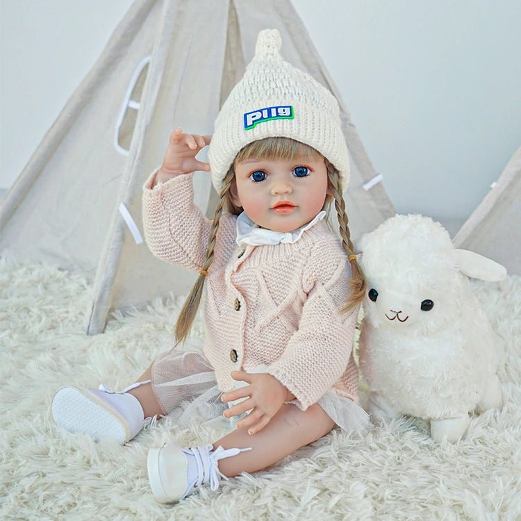 cute toddler doll with long yellow hair, blue eyes, and a beige outfitchimidoll