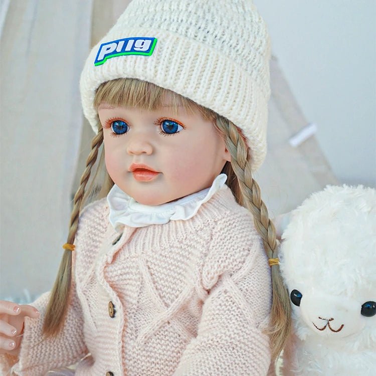 cute toddler doll with long yellow hair, blue eyes, and a beige outfitchimidoll