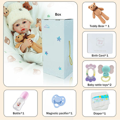 Package overview with accessories: teddy bear, birth certificate, bottle, magnetic pacifier, and diaper.