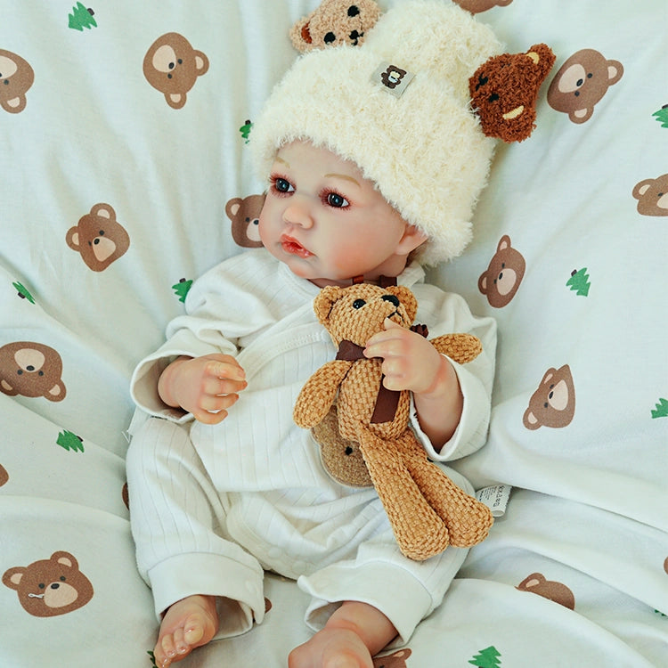Doll seated, gazing at the teddy bear in a gentle embrace.