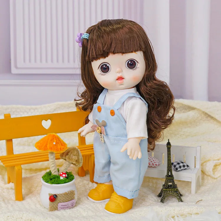 A charming doll in a white blouse and soft blue dungarees decorated with a plush bear, near a model of the Eiffel Tower.